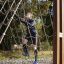Man climbing on V-shape Net Large climbing net in an outdoor playground.