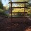 Step And Climb wooden ladder installed in an outdoor playground area.
