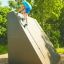 Boy climbing the Climbing Ramp steel structure on a playground.