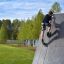 Boy climbing the Climbing Ramp steel structure outdoors.