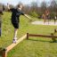 Child balancing on a Balance beam outdoors.