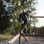 Man using the Easy Balancer outdoor fitness equipment in a park.