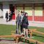 Three girls balancing on Easy Balancer outdoor playground equipment.