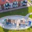 Playground structure resembling a ship with slide and climbing elements in a residential area.