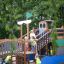 Children playing on the Majestic ship with slide in a playground.