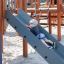 Child sliding down the grey slide on Majestic ship with slide playground