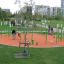 Single swing Hammock in an outdoor playground with people.