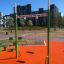 Single Swing playground equipment on orange rubber surface in urban park