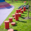 Red jumping pegs (5 pcs.) in playground.