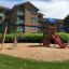 Double Swing with Tower playhouse and slide in residential area playground