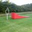 Red training ramp and target stand on grass field, Aim Practice I