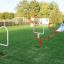 Outdoor playground equipment Aim Practice II on a grassy field with various obstacles.