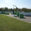 Outdoor playground with a punching bag and green equipment.