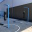 Punching bag suspended on blue metal frame in outdoor playground area