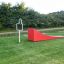 Ramp: Red outdoor play ramp in a grassy park area.