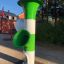 Green and white Ball catcher in a playground setting.