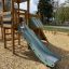 Wooden Romping Center single slide in a playground.