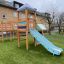 Children's playground with Romping Center single slide in residential area.