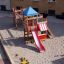 Playground equipment Romping Center with single red slide and colorful towers