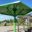 Green Umbrella playground shade structure in an outdoor park.