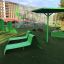 Green outdoor playground equipment including the Umbrella sunshade.