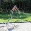 Single Swing (BNS) playground swing set with a circular seat in a park.