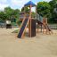 Twister castle with slide on a sandy playground