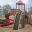 Playground structure with red slide and climbing elements, named Twister castle with slide.