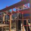 Twister castle with slide in playground with climbing net and red handles.