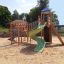 Twister castle with slide on a sandy playground.