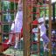 Children playing on the Twister castle with slide outdoor playground equipment.