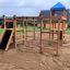 Gorilla wooden playground set with slides and climbing structure in a park.