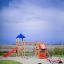 Gorilla playground set with slides and seesaw on a sunny day