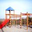 Outdoor playground structure Gorilla with slides, climbing nets, and tower.