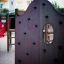 Motor Function Center wooden playhouse with climbing wall in residential area playground