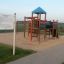 Motor Function Center wooden playhouse on a sandy playground
