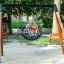 Children playing on a Double Swing (BNS 90cm) at a park.