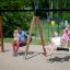 Double Swing (BNS 90cm) in use at a playground with families enjoying the swings.