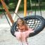 Girl sitting on Double Swing (BNS 90cm) in a playground.