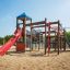 Challenger castle with slide on a sandy playground