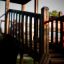 Wooden play structure with railing, part of Challenger castle with slide.