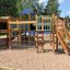 Square Play castle with slide for children in outdoor playground