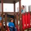 Children playing on the Square Play castle with slide.