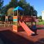 Square Play castle with slide in a playground.