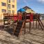 Square Play castle with slide in a playground.