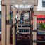 Child playing on Searobber Castle wooden playground structure with slide.