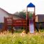 Searobber Castle castle with slide in a playground surrounded by flowers.