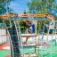 Child climbing on Andromeda steel structure playground equipment.