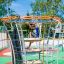 Child climbing on Andromeda steel structure playground equipment.