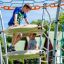 Children playing on Andromeda steel structure in playground.